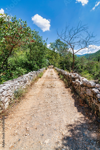 Fototapeta Naklejka Na Ścianę i Meble -  View of the traditional stone bridge of Agios Polykarpos in the western Taygetos, Greece, in summer.
