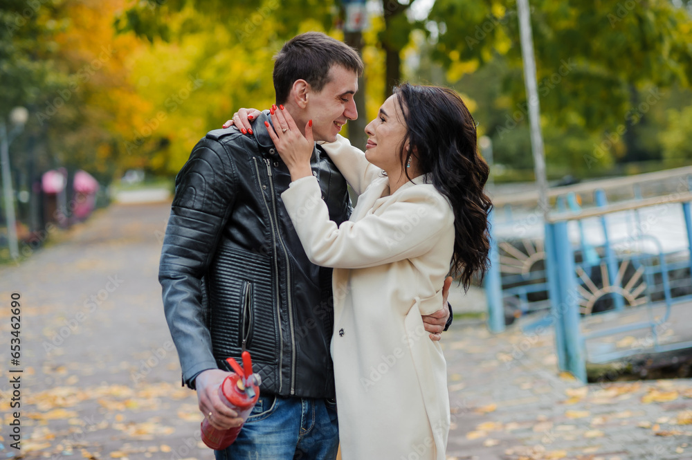 A man hugs a pregnant woman. A man uses a fire extinguisher to determine the sex of his child. Gender party. Happy parents A man hugs a pregnant woman. A man uses a fire extinguisher to determine the sex of his child. Gender party. Happy parents