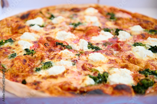 Extreme closeup of traditional Italian pizza Margherita, garnished with fresh basil leaves. Italian cuisine and culture. Food