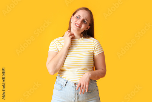 Allergic young woman scratc...