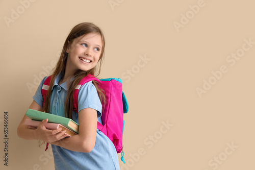 Little schoolgirl with book...