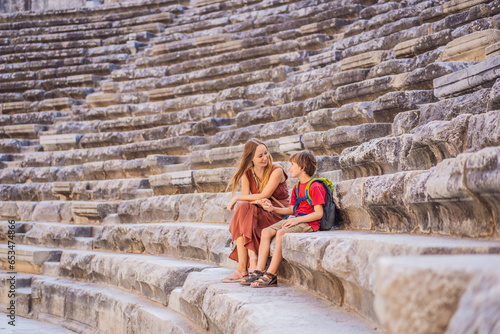 Canvas Print mother and son tourists explores Aspendos Ancient City