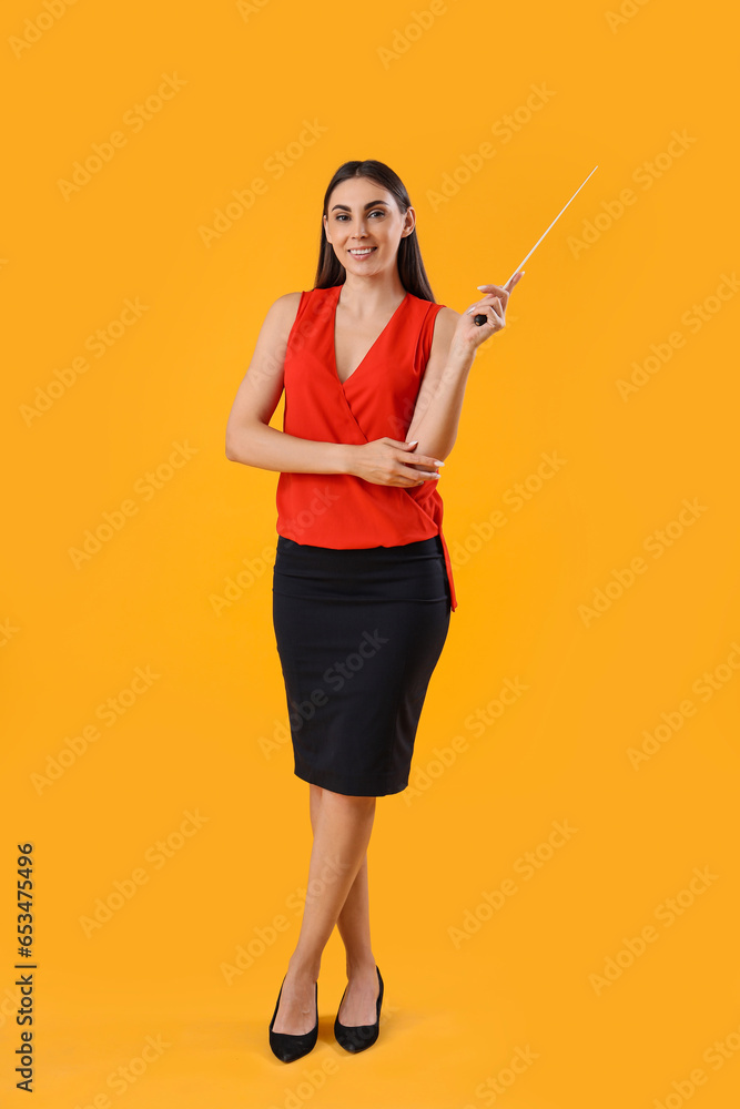 Young female teacher with pointer on yellow background Young female teacher with pointer on yellow background