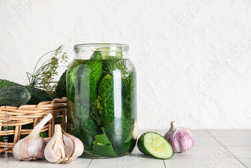 Fototapeta Naklejka Na Ścianę i Meble -  Jar with cucumbers for canning and fresh vegetables on table