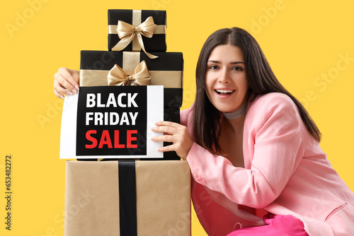 Young woman with gift boxes...