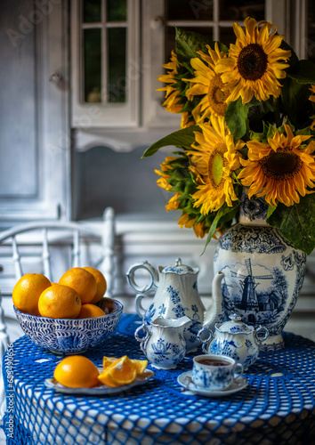 still life with sunflowers and orange. Blue and yellow colors. Delft blue. beautiful picture. autumn still life.