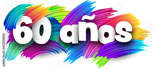 60 years at spanish paper word sign with colorful spectrum paint brush strokes over white.