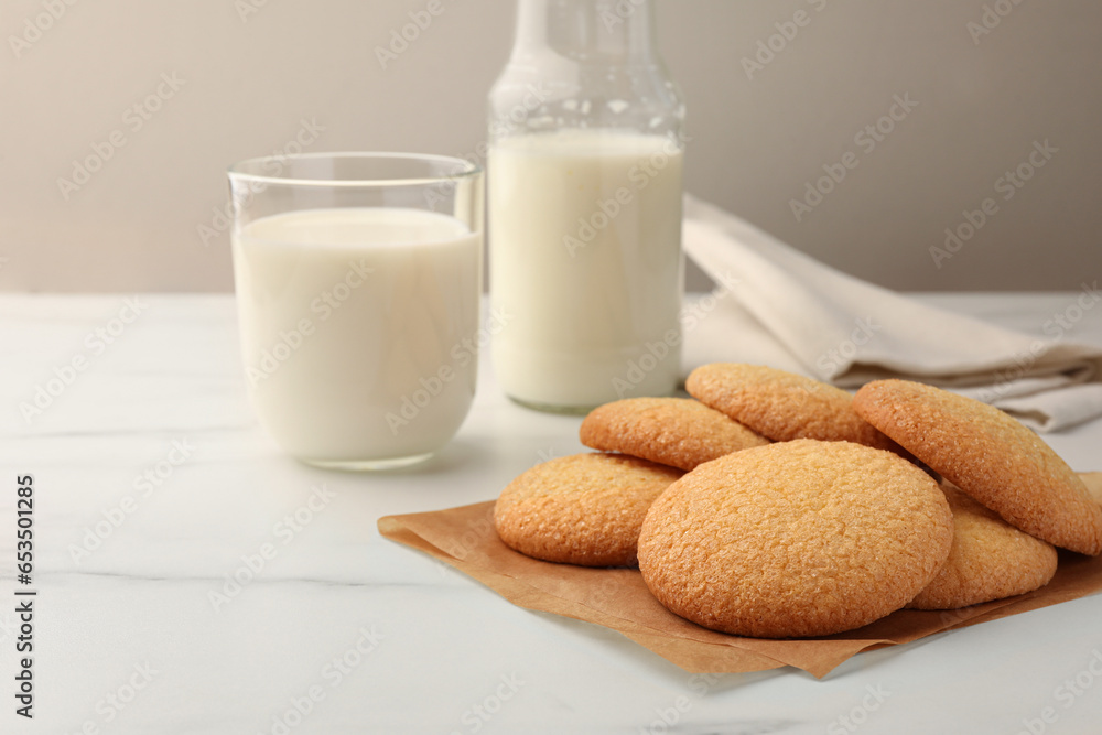 Delicious Danish butter cookies and milk on white marble table, closeup. Space for text Delicious Danish butter cookies and milk on white marble table, closeup. Space for text