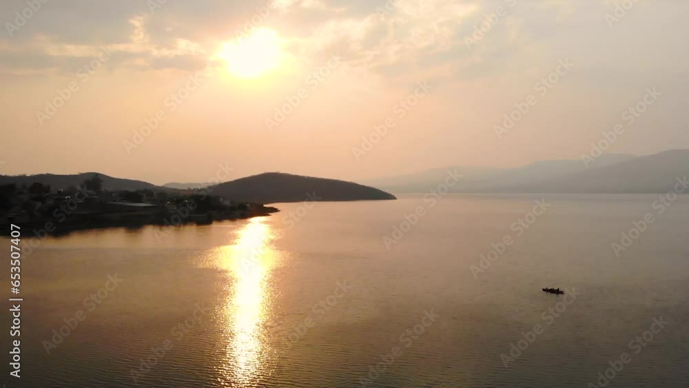 Aerial View of Happy Couple Kayaking into a Scenic Sunset on a Tranquil Lake Aerial View of Happy Couple Kayaking into a Scenic Sunset on a Tranquil Lake