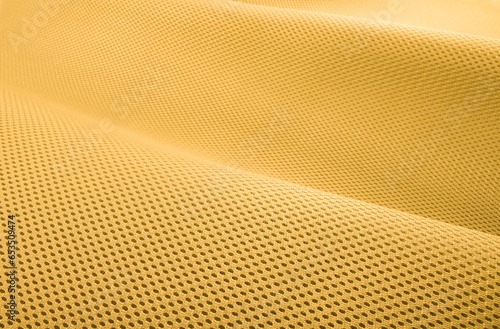 Rough yellow fabric texture, cotton knitted fabric, modern waterproof flexible temperature control materials, multifunctional smart textile close-up, selective focus, does not tear