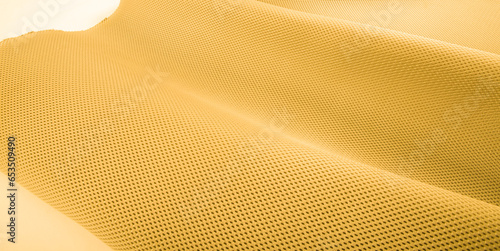 Rough yellow fabric texture, cotton knitted fabric, modern waterproof flexible temperature control materials, multifunctional smart textile close-up, selective focus, does not tear