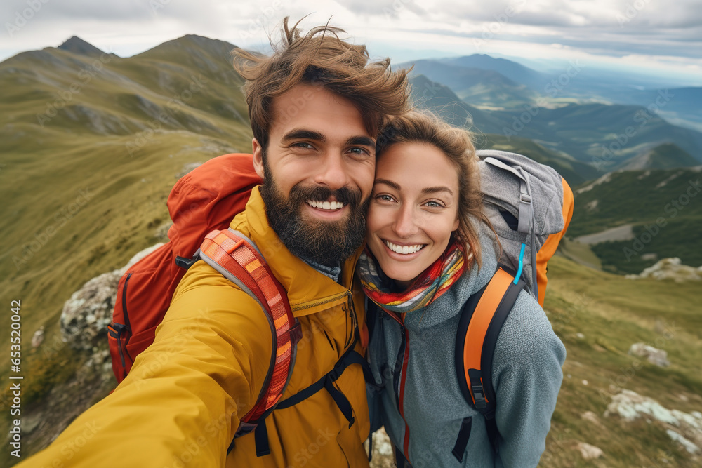 Young couple man and woman hiking outdoors in mountains in fall