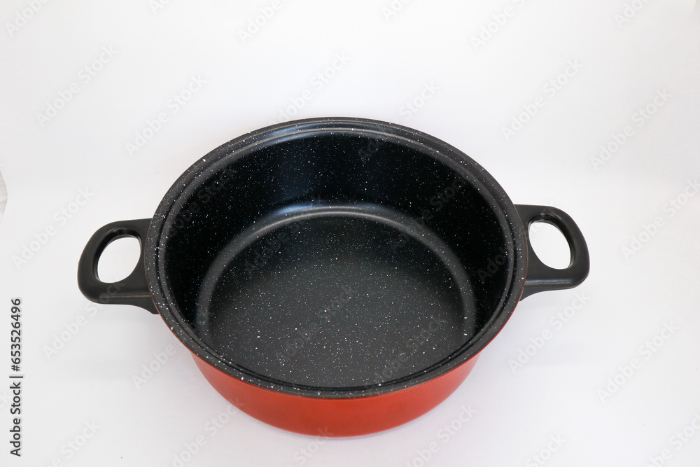 Black and red non-stick pan for cooking in the kitchen, pan for cooking vegetables and cooking water for household needs, isolated on white