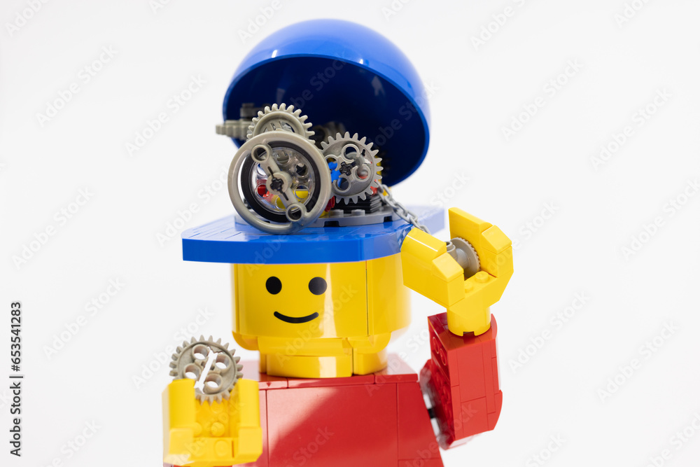 Fototapeta premium Hong Kong - September 28 2023: small worker fix the gear wheels in the head of giant man