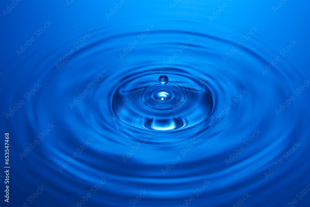 Group of water droplets fall and bounce on a water surface Group of water droplets fall and bounce on a water surface