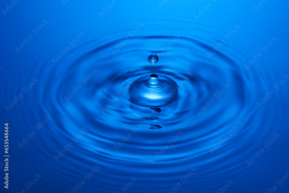 Group of water droplets fall and bounce on a water surface Group of water droplets fall and bounce on a water surface