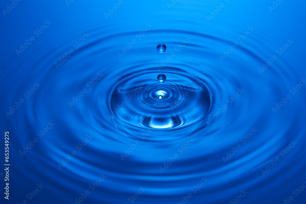 Group of water droplets fall and bounce on a water surface Group of water droplets fall and bounce on a water surface