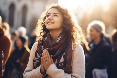 Hand clasped woman is praying in church with sunshine flare effect © pariketan