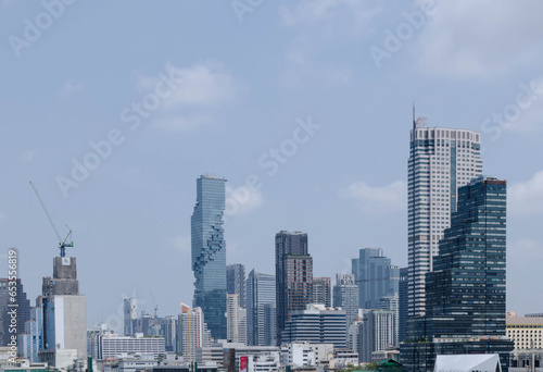 panorama landscape view of chaopraya river with river water boat transportation and background of bangkok city skyline with many highrise skyscraper among central district area in daytime © Surakit
