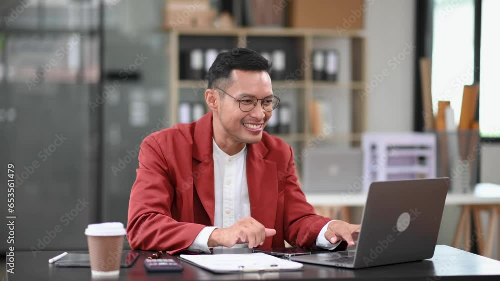 Asian business man are delighted and happy with the work they do on their tablet, laptop and taking notes at the modern office.. Asian business man are delighted and happy with the work they do on their tablet, laptop and taking notes at the modern office..