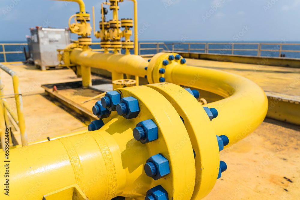 Oversized flange, large tube painted yellow with lots of bolts and nuts painted blue.