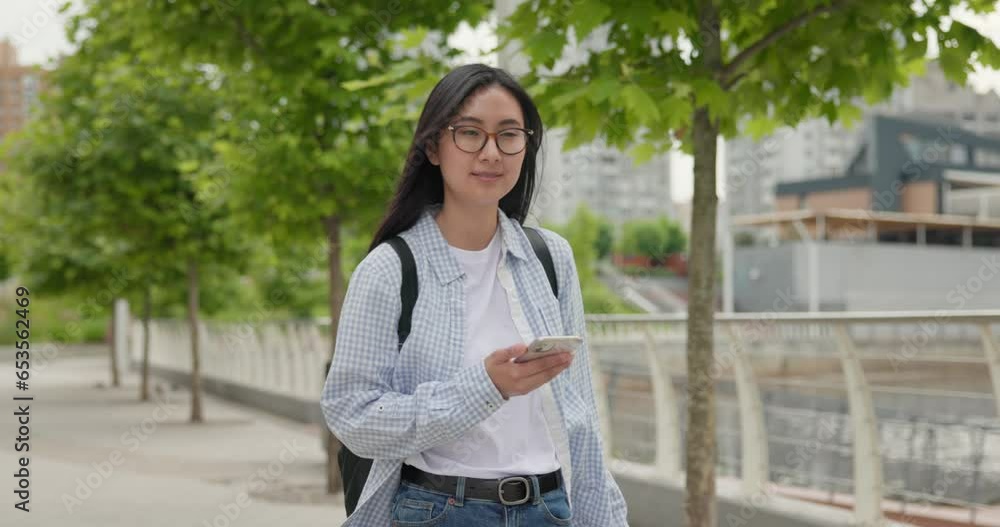 Young asian woman wearing casual clothes with backpack on the back walking at the city Young asian woman wearing casual clothes with backpack on the back walking at the city