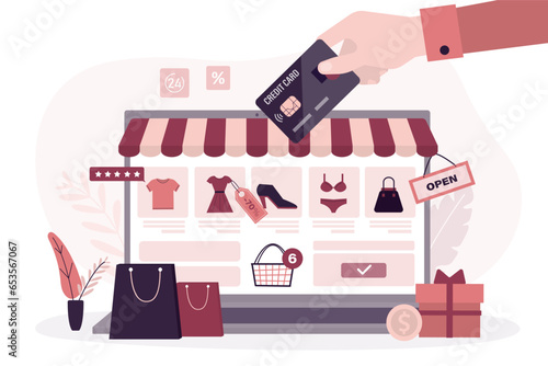 Online shop application on laptop screen. Shopping on internet, marketplace. consumer hand uses credit card to pay for an order in online store.