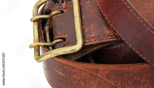 Leather belt with a buckle on a white background. Close-up.