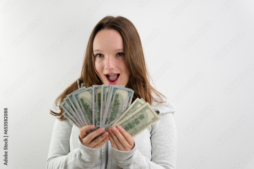 happy woman showing dollar bills money and smiling isolated on grey background. High quality photo happy woman showing dollar bills money and smiling isolated on grey background. High quality photo