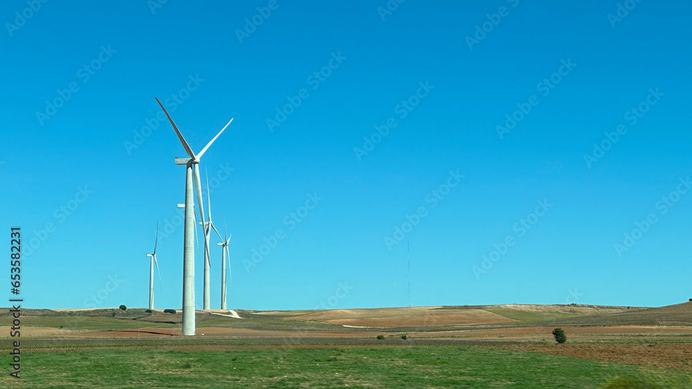 Windmills on a sunny day with a cloudless sky and space for text. Windmills on a sunny day with a cloudless sky and space for text.