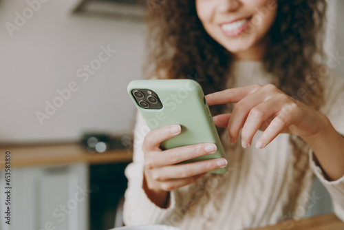 Картината върху платно Cropped young smiling housewife woman wearing casual clothes sweater hold use mo