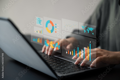 Businesswoman using laptop analyzing business growth graph data and progress, compass of navigate guiding market direction. Investment, banking and finance, strategy, Global economy.