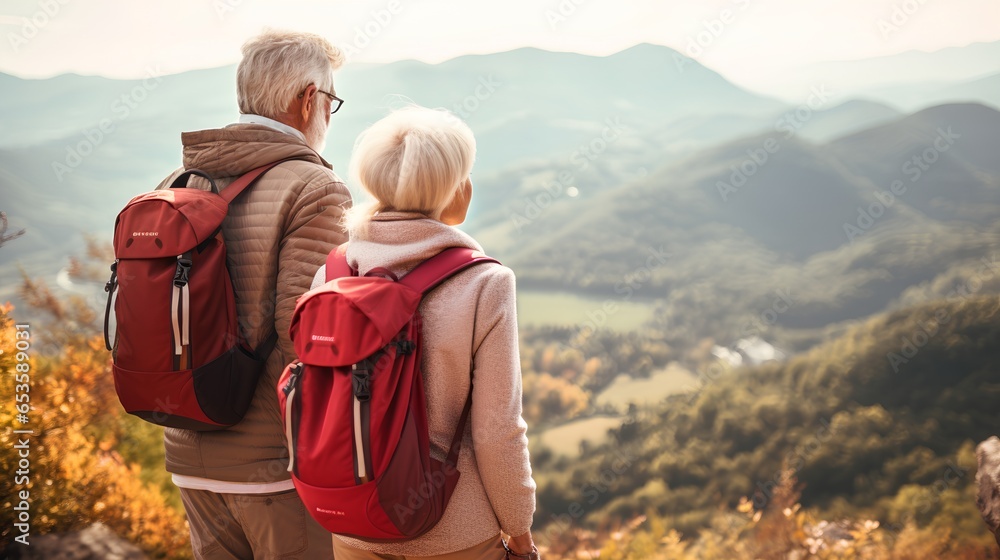 An active senior couple is seen traveling, hiking through a picturesque mountainous landscape. They are dressed in hiking gear, carrying backpacks, and enjoying the breathtaking scenery around them.
