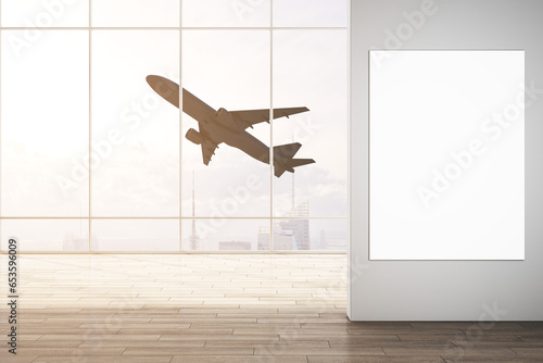 Modern airport interior with mock up poster on wall and flying airplane seen through panoramic window with city view and daylight. Take off, travel and transportation concept. 3D Rendering.