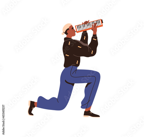 Musician playing melodica. Young man, music instrument player, blowing and pe...