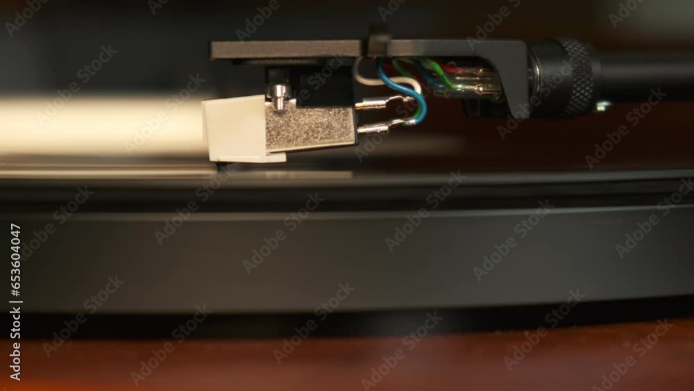 Close up view of a turntable needle with platter spinning, slow motion 4K Close up view of a turntable needle with platter spinning, slow motion 4K