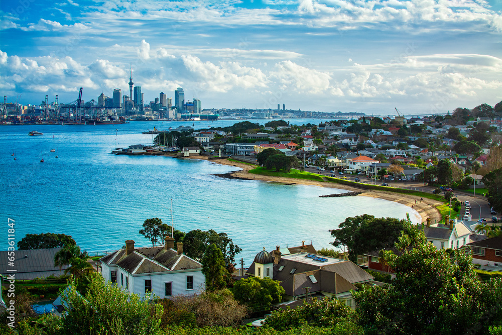 Looking over historical suburb of Devonport on the shore of Auckland Harbour. Distant skyline of Auckland CBD on the horizon. North Island, New Zealand - obrazy, fototapety, plakaty 