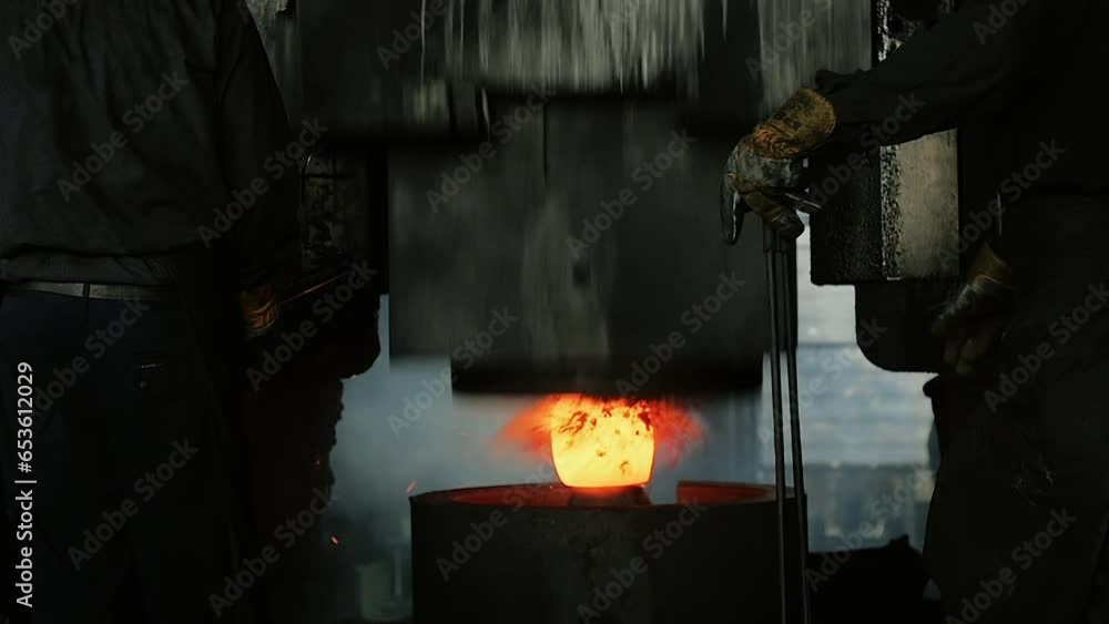 Press at work on a piece of hot metal Press at work on a piece of hot metal