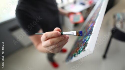 Obraz na plátně Close-up of persons hand creating abstract painting on canvas combine styles