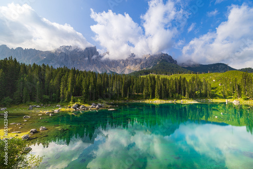 A view of the Carezza lake and the countryside into Val di Fassa