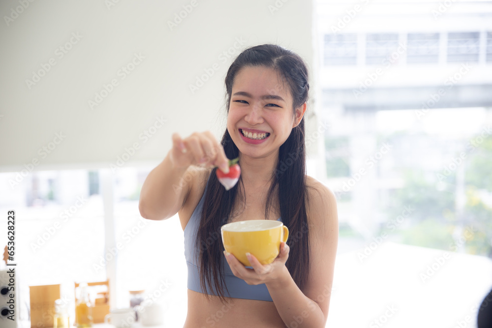 Healthy and Sportive woman eating apple, Pretty girl wearing sportswear preparing healthy food for breakfast after training Healthy and Sportive woman eating apple, Pretty girl wearing sportswear preparing healthy food for breakfast after training