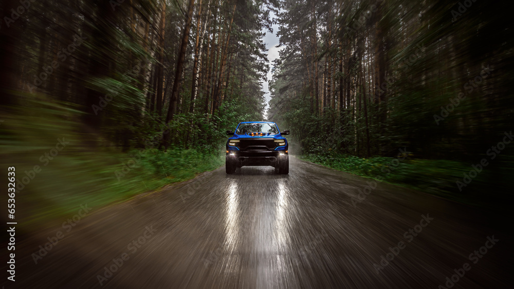 A blue new pickup truck is driving along a highway in the forest with a blurred background. Fast driving - obrazy, fototapety, plakaty 