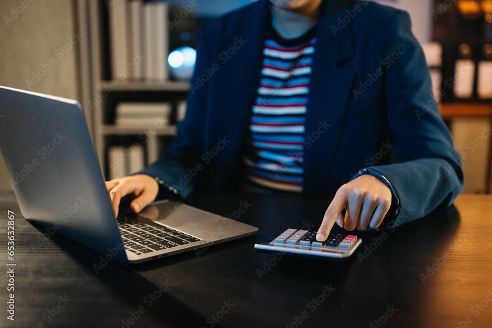 Women counting coins on calculator taking from the piggy bank. hand holding pen working on calculator to calculate on desk about cost at home office... Women counting coins on calculator taking from the piggy bank. hand holding pen working on calculator to calculate on desk about cost at home office...