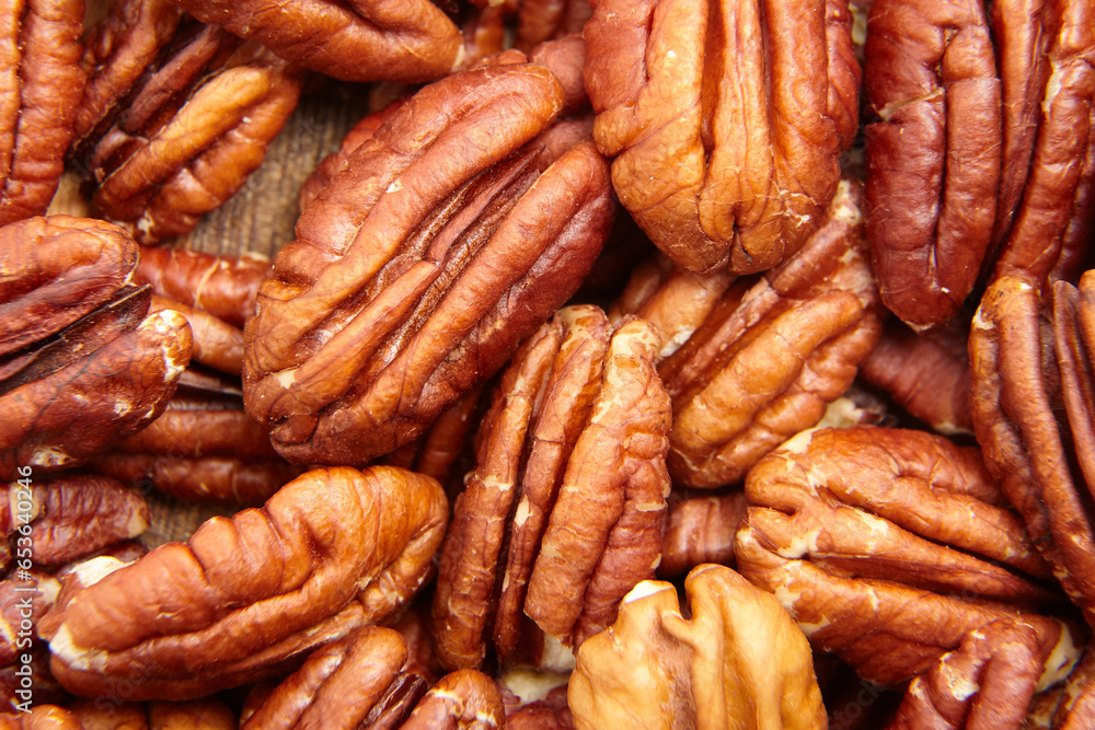 Pecan nuts kernel texture background closeup. Heap of peeled pecan halves. Their halved forms fit like nutty puzzles Pecan nuts kernel texture background closeup. Heap of peeled pecan halves. Their halved forms fit like nutty puzzles