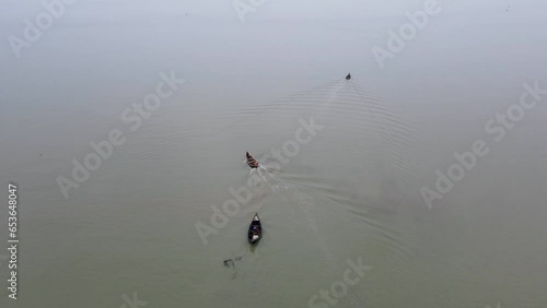 Aerial View Of An Engine Motor And Fishing Boat Leaving Shore Of Kuakata In Bangladesh. photo