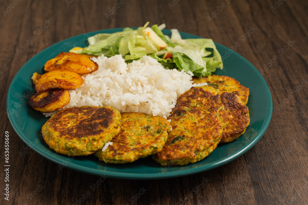 Oatmeal fritters with vegetables and white rice served on a plate on a wooden table. Healthy food. Oatmeal fritters with vegetables and white rice served on a plate on a wooden table. Healthy food.