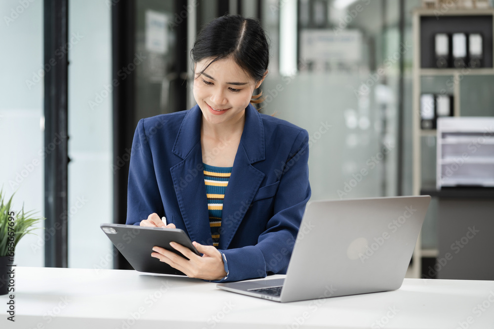 Women work on laptop and Tablet on the table at the office with information documents. Women work on laptop and Tablet on the table at the office with information documents.