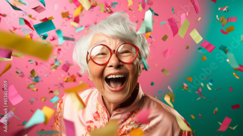 Happy laughing woman with falling confetti. Birthday, New Year, fun celebration party © ReneLa/Peopleimages - AI