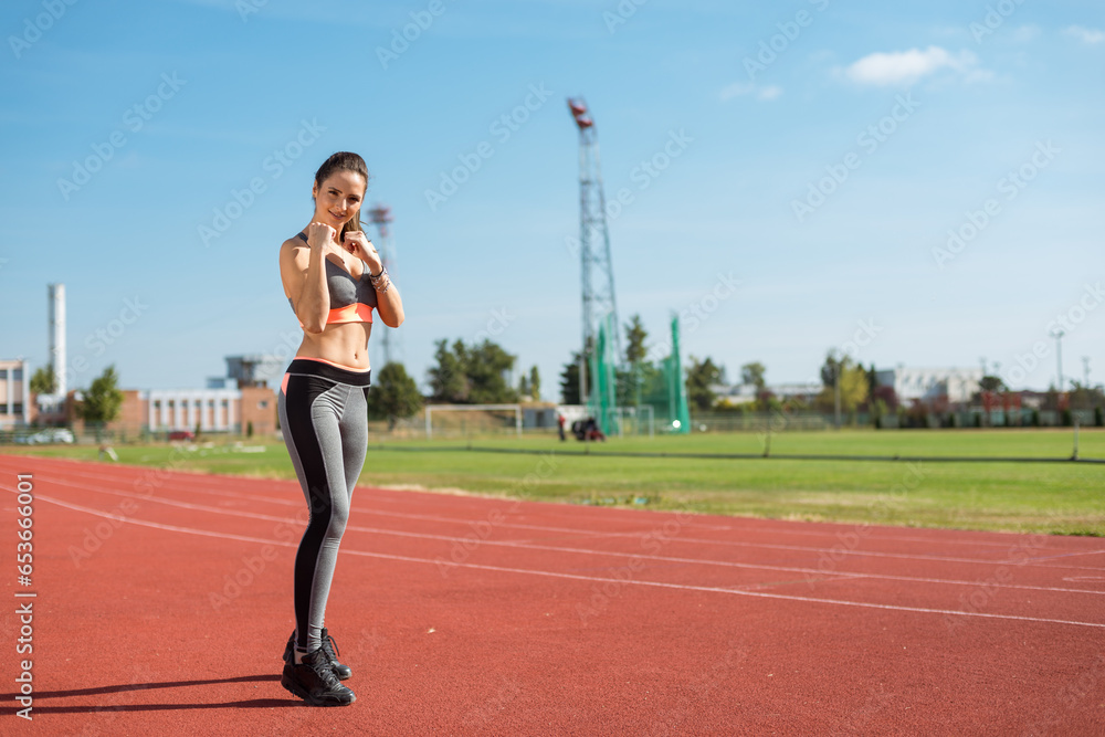 Beautiful woman training on the tracks on a sunny morning