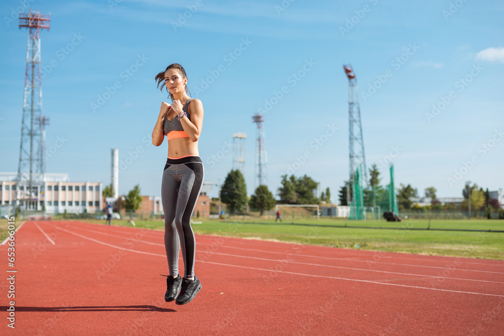 Beautiful woman training on the tracks on a sunny morning